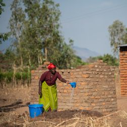 Ligineti Nayinayi a Cyclone Freddy Survivor is seen watering mud for making bricks at her village in Phalombe southern Malawi