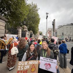 Two young women holding signs at a climate strike.