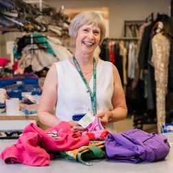 Barbara, a volunteer at Oxfam Holywood Superstore, sorting new donations.