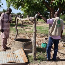 Damaged well in Bla after torrential rains in July–August 2024, with two men inspecting the site.