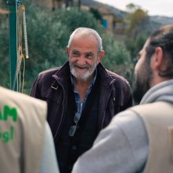Oxfam staff having a conversation with Awad, Deir Mimas resident about the war and the water shortage.