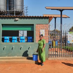 Tariro Zvirevo fetching clean water at an Oxfam water Kiosk in Kuwadzana.