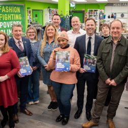 Oxfam staff in the Superstore shop in Holywood standing holding the GEM brochure