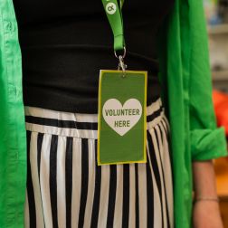Close up of an Oxfam lanyard that says "Volunteer Here"