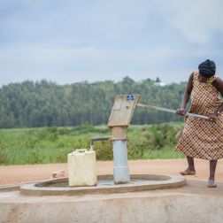 Adoko Juliana fetching water from the borehole at Bwiriza Zone, in Kyaka II Settlement.