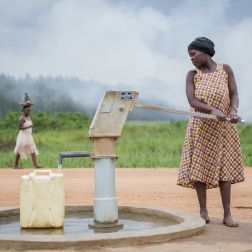 Adoko Juliana fetching water from the borehole at Bwiriza Zone, in Kyaka II Settlement.