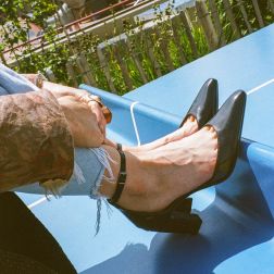 Emma Doran's pair of black heels in a blue slide