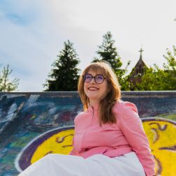 Comedian Bláithín de Burca sitting at a skate park.