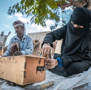 Nazrah Mohsen and her husband building a beehive