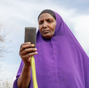 Ebla Hussein Ahmed reading a message from her mobile phone