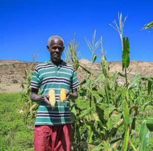 Farmer holding his farm production.