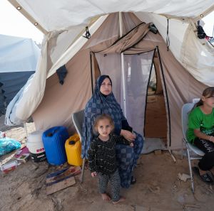 A mother and her children currently residing in the Khan Younis refugee camp, which was established by the United Nations Relief and Works Agency (UNRWA) and is now known as the Khiam (Tents) Camp.