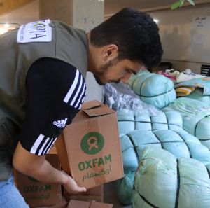 Oxfam's partner staff distributing hygiene management kits