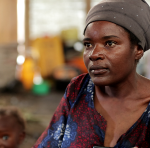 Feza Damani, mother of seven, fled the village of Kiwanja in the Rutshuru region. She has been living in Rusayo since September 2023. Mrs Feza and her seven children now live in a communal warehouse with several other displaced people. Since her arrival, she and others have never received any humanitarian aid.