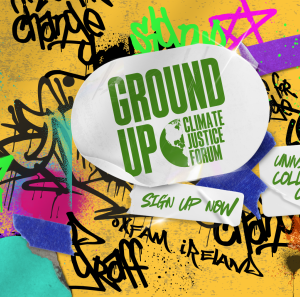 A graffiti wall with a sticker in the middle with the Ground Up Climate Justice Forum logo and stickers saying Sign Up Now and University College Cork