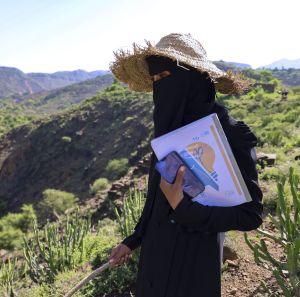 Nahla Abdo, 25, mobile technician, with phone and guidebook in Al-Ma’afer, Taiz.