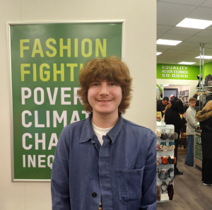 Marius, Volunteer from Norway standing in an Oxfam shop