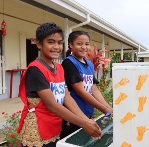 Nine year old Christopher and Nanise, washing their hands in their primary school
