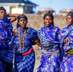 The women of Segei Machesa self help group sing in front of their newly constructed social hall.