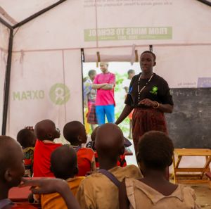Adome Mary teaching kids at the mobile learning center