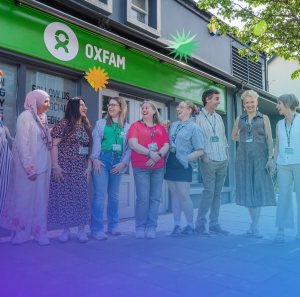 Groups of staff and volunteers in front of an Oxfam Ireland's Shop