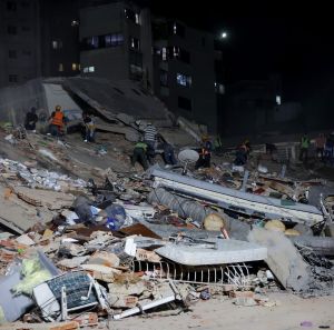 People and rescuers work on the debris from the Rita building after a magnitude 7.2 earthquake struck Venezuela and other regions in the Caribbean 