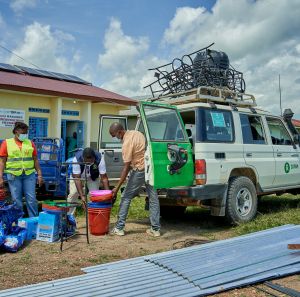 Teams outside a white van in DRC.