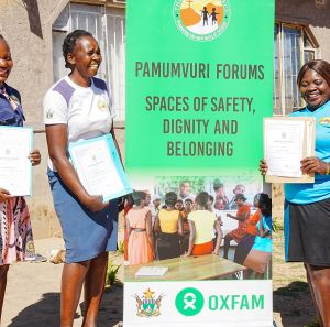 Young women in Zimbabwe holding certificates