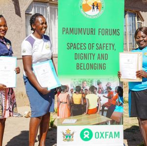 Young women from Zimbabwe holding their certificates