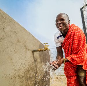 Ekai Adamson Samuel enjoying clean water at the water point in Moruese village.